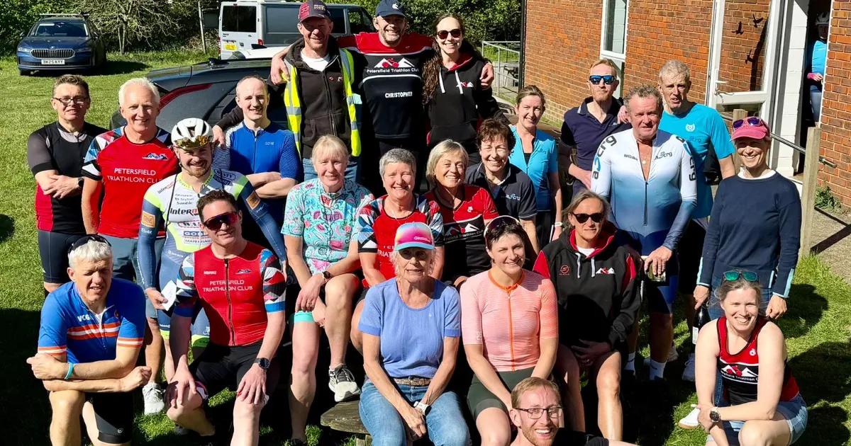 Cycling club group members huddled and relaxing