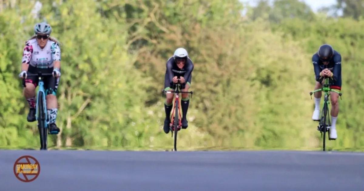 Three cyclists racing head-on 