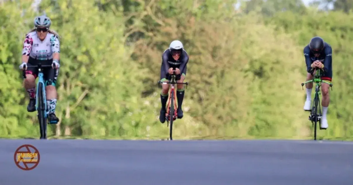 3 cyclists racing head-on